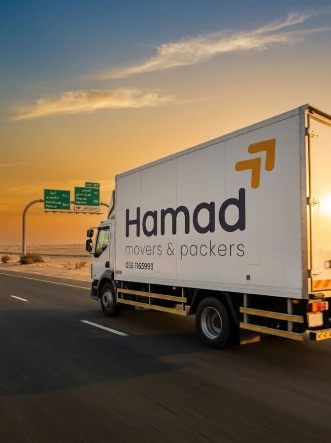 Hamad Movers branded truck driving on a UAE desert highway during an inter-emirate relocation - Hamad Movers Dubai