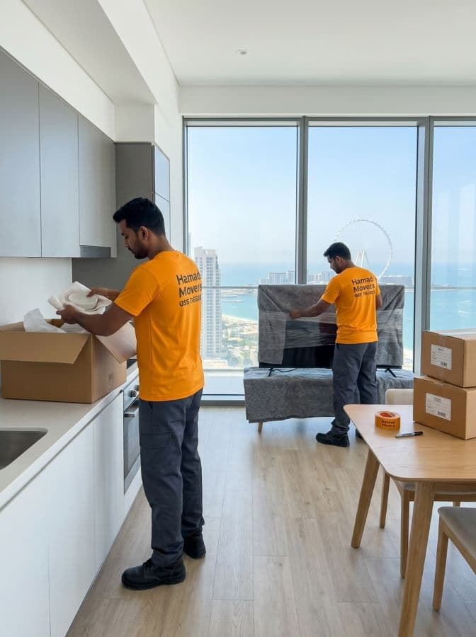 Hamad Movers team packing and boxing household items inside a modern high-rise apartment in Dubai - Hamad Movers Dubai