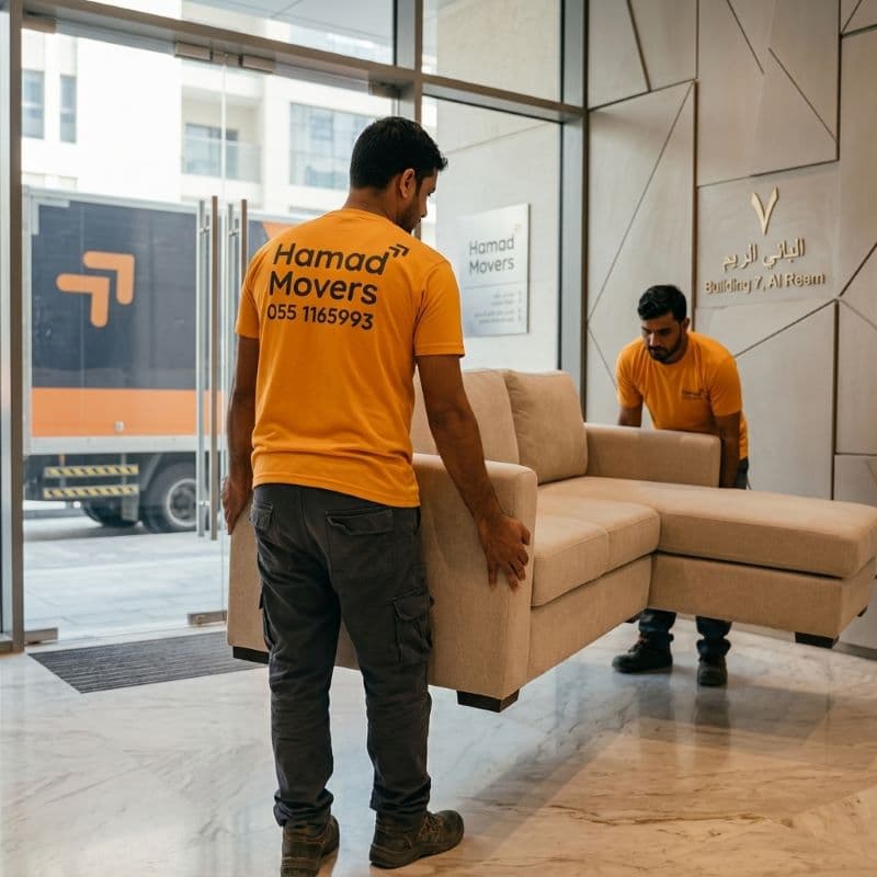 Hamad Movers team carrying furniture during a villa relocation in Abu Dhabi, UAE